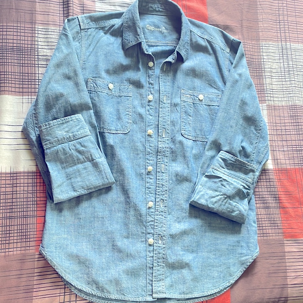 It is a little small for my son. Very nice sky blue color button long sleeves